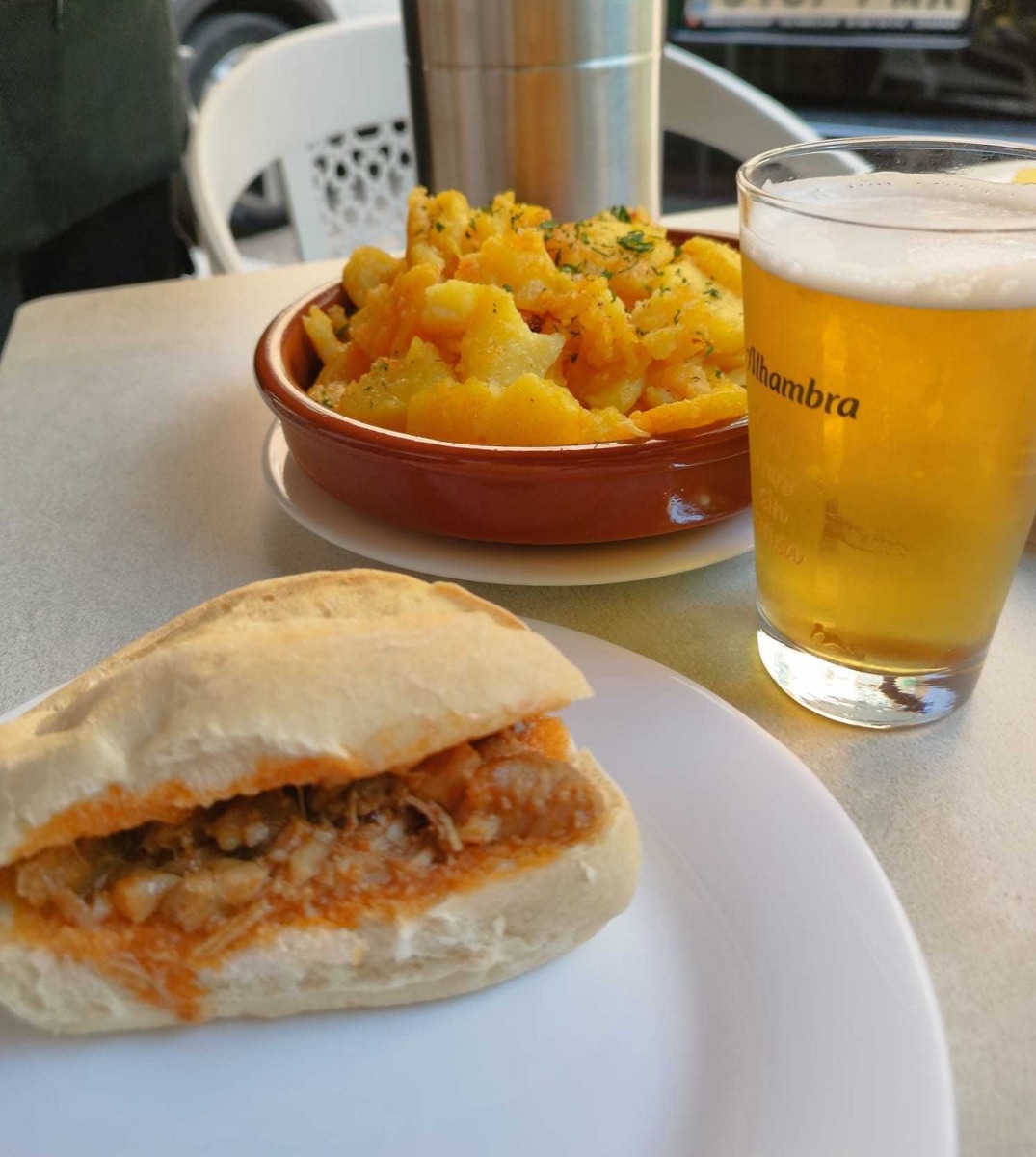 Bocata con papas y caña en la terraza